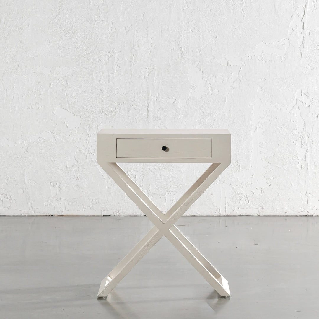 AMARA MID CENTURY CROSS LEG BEDSIDE TABLE  |  BEIGE ARAVA