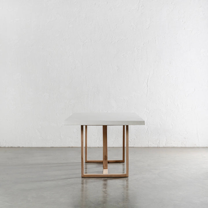 ARIA HALMSTAD DINING TABLE  |  BIANCO CIMENT + TEAK LEGS END VIEW