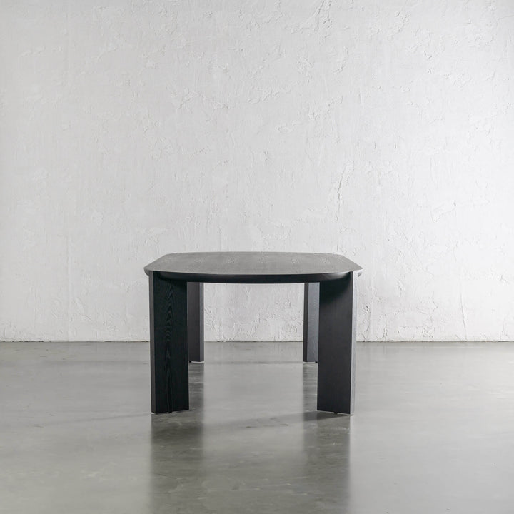 CASSAN ROUNDED DINING TABLE END VIEW  |  BLACK NOIR WOOD GRAIN 