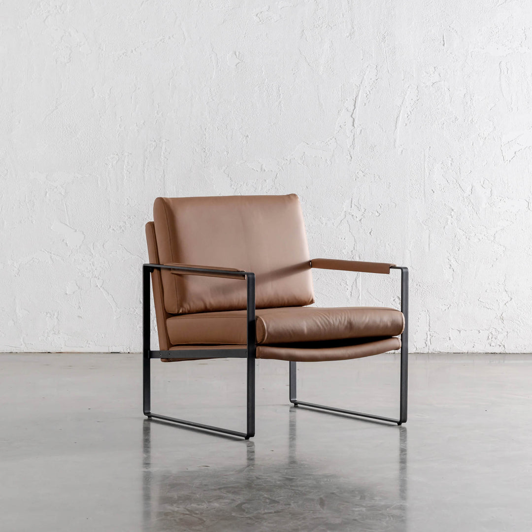 PAMINA FAUX LEATHER ARMCHAIR ANGLED  |  TERRA CIGAR TAN