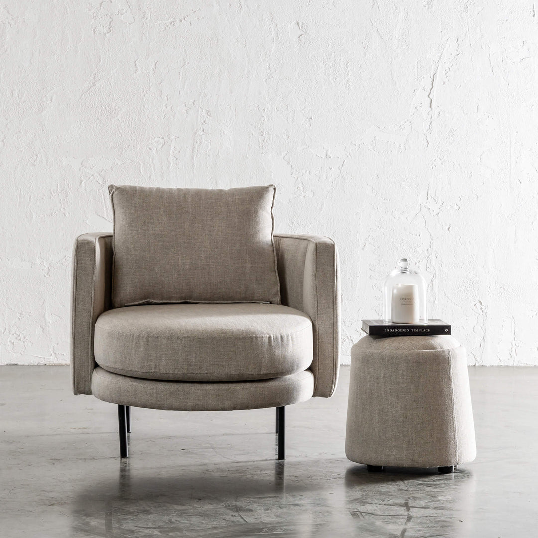 CARSON CURVE ROUND OTTOMAN  |  JOVAN EARTH WITH CARSON MODERNA RIBBED ARM CHAIR